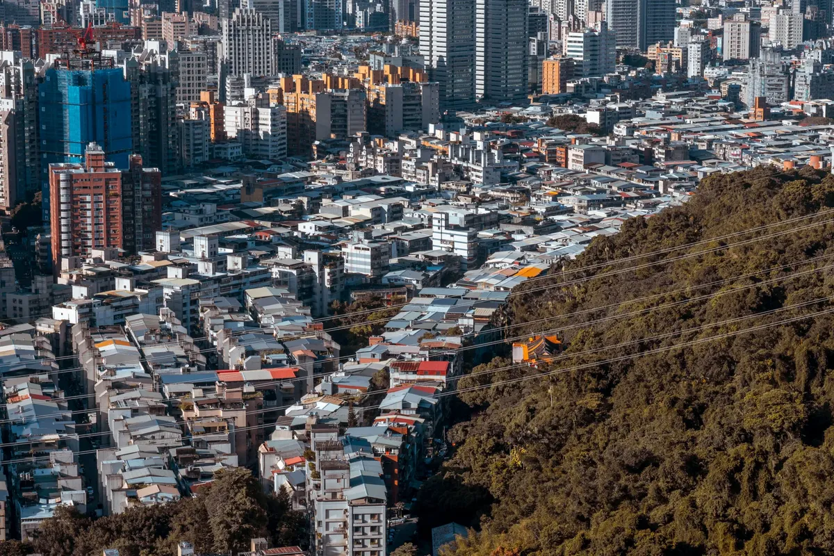 Aerial view of a densely populated residential area with skyscrapers in Taipei, Taiwan.