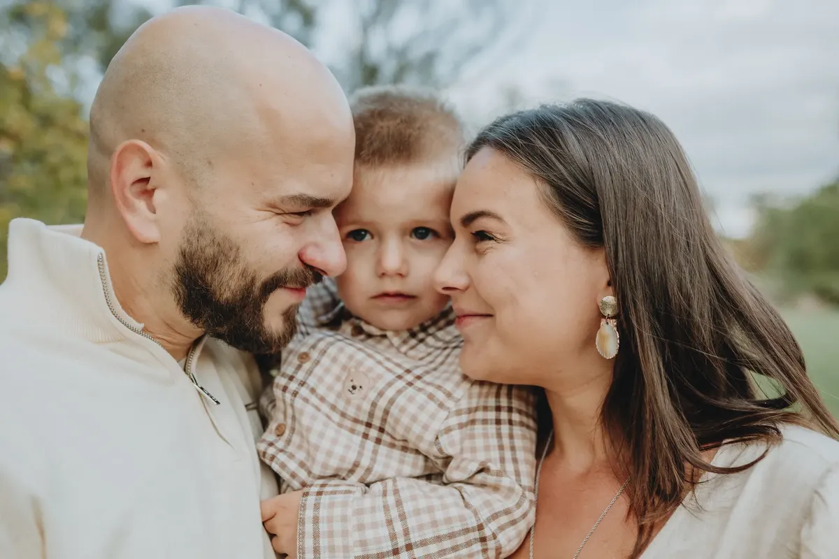 A joyful close-up of a happy family embracing outdoors, capturing warmth and love.